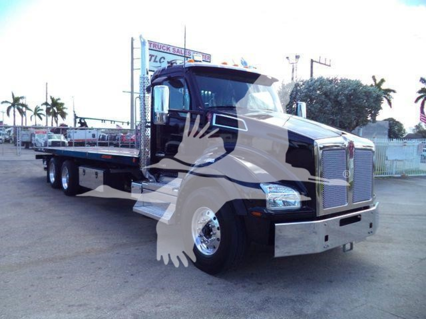 Kenworth T880 rollback truck in service body configuration, front grille and chrome bumper visible; no legible model badges or price text.