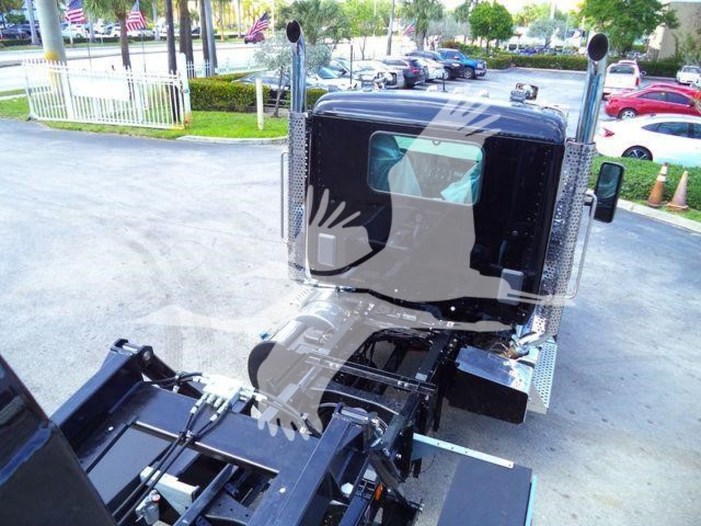 Kenworth T880 truck cab and chassis with vertical exhausts, rear view showing driver seat area and chassis; no visible text on the image.