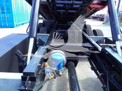 Kenworth T880 rollback chassis interior view showing air compressor and hydraulic lines with tires in background