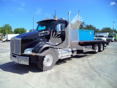Kenworth T880 rollback truck in black, side view showing blue cargo bed, chrome front grille, and multiple axles.