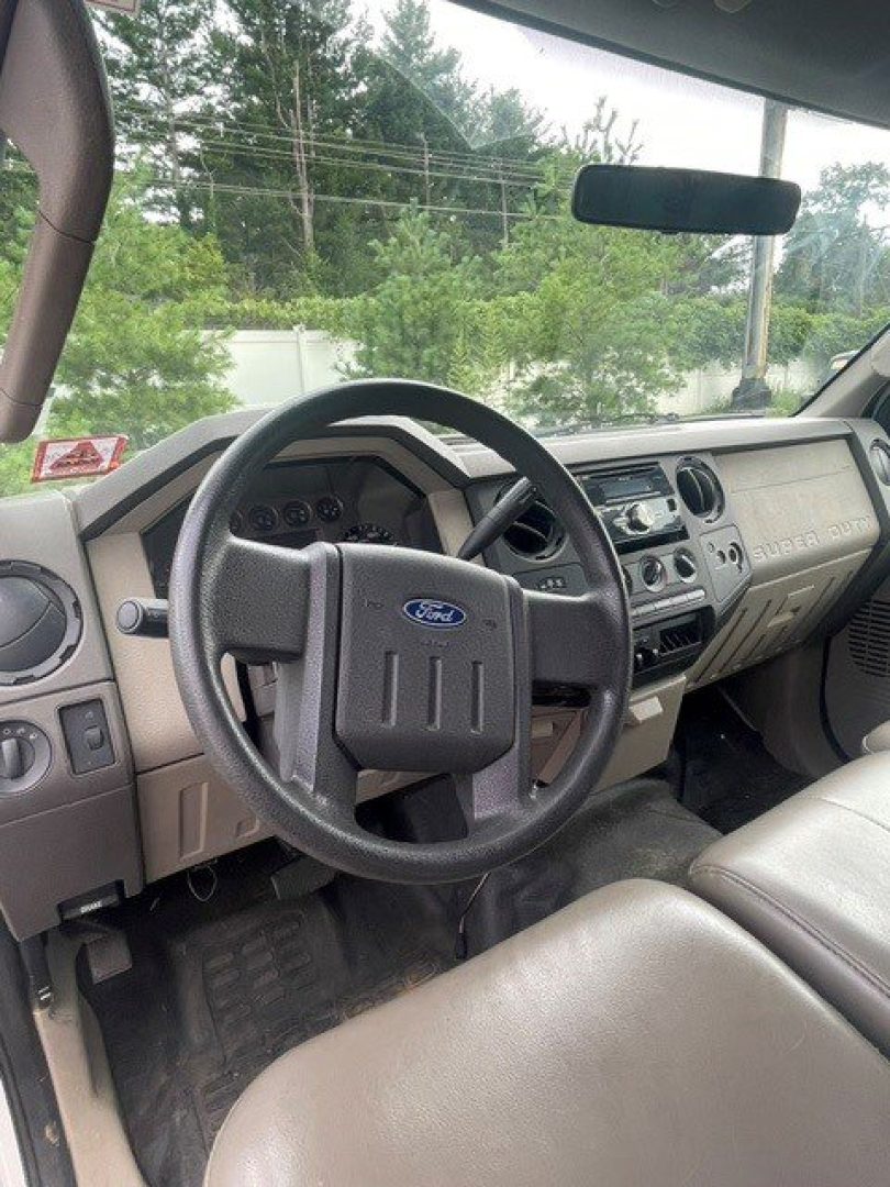 Ford F-250 Super Duty interior steering wheel dashboard and front seats, view of driver-side area.