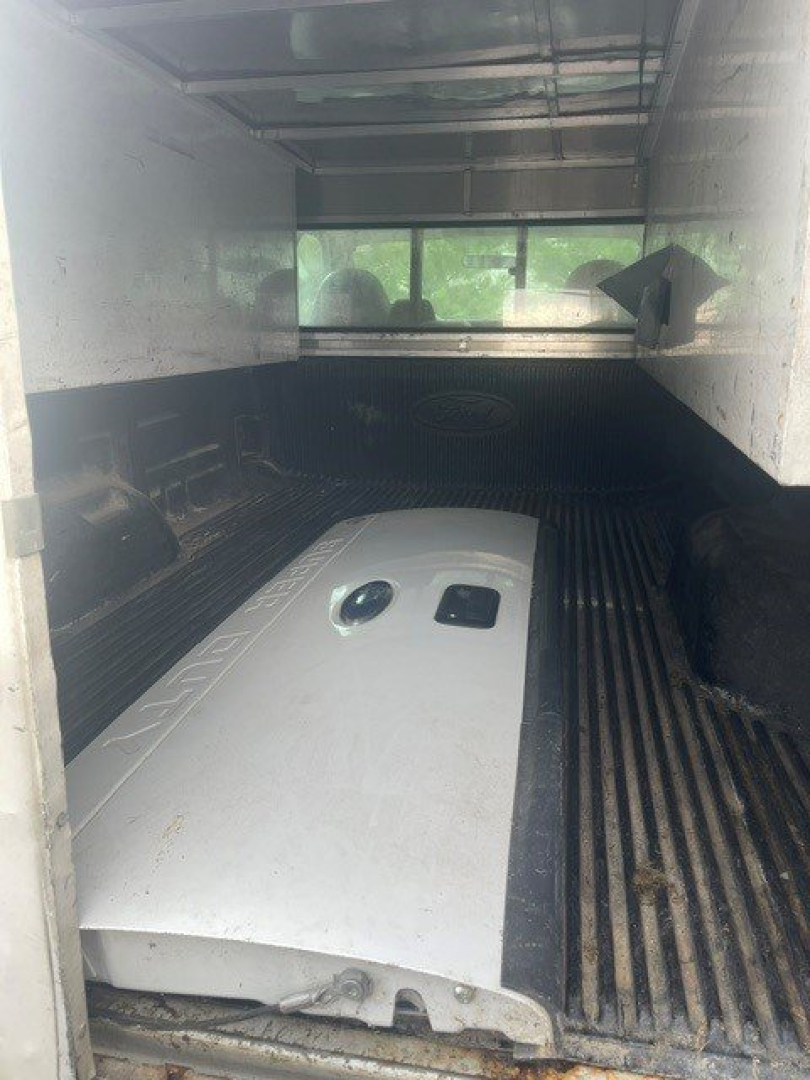 Ford F-250 SRW bed and cargo area with large fuel tank or equipment installed inside truck bed.