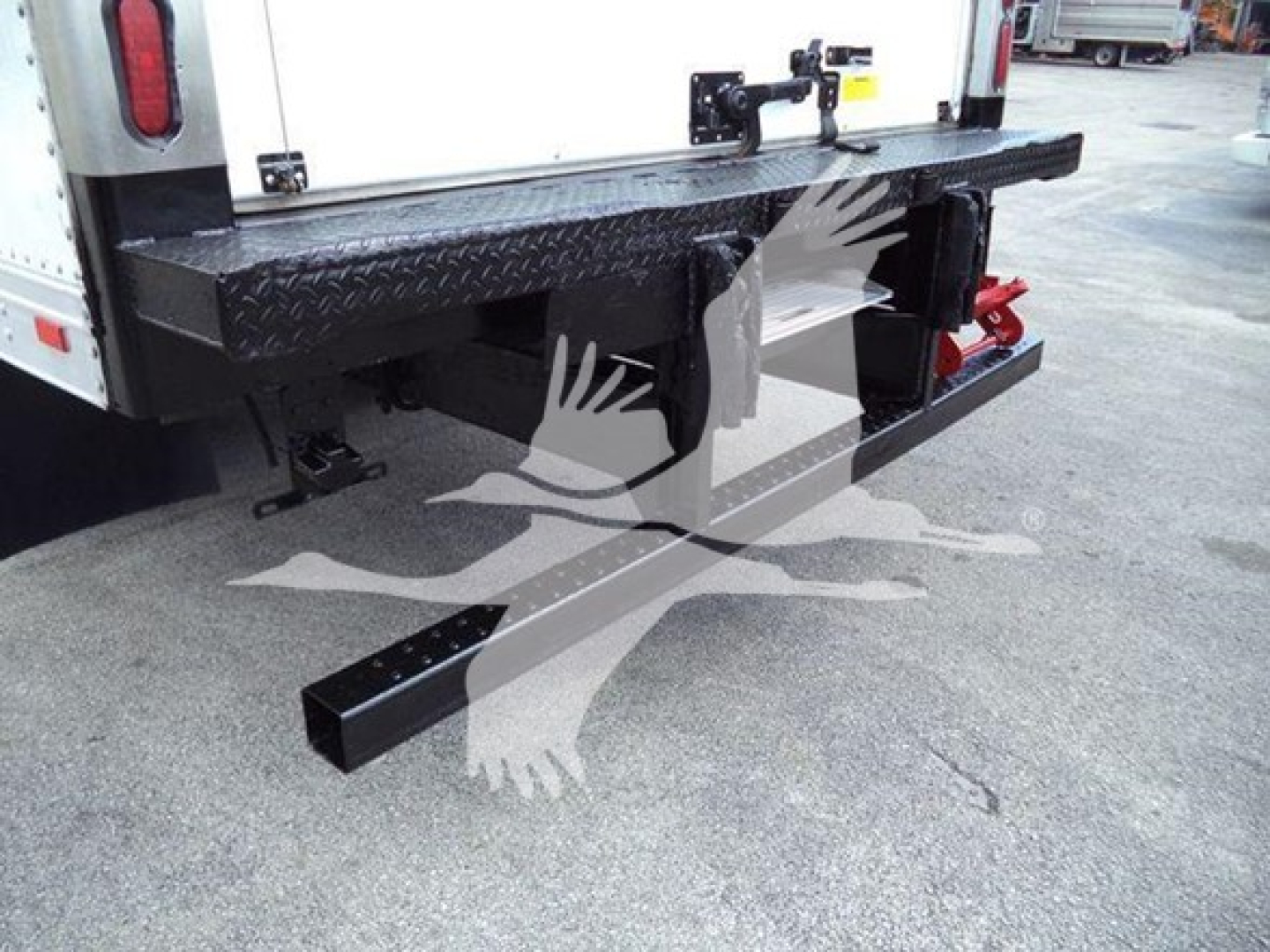 Rear view of a 2019 Hino 195 refrigerated truck showing a heavy-duty bumper and undercarriage components.