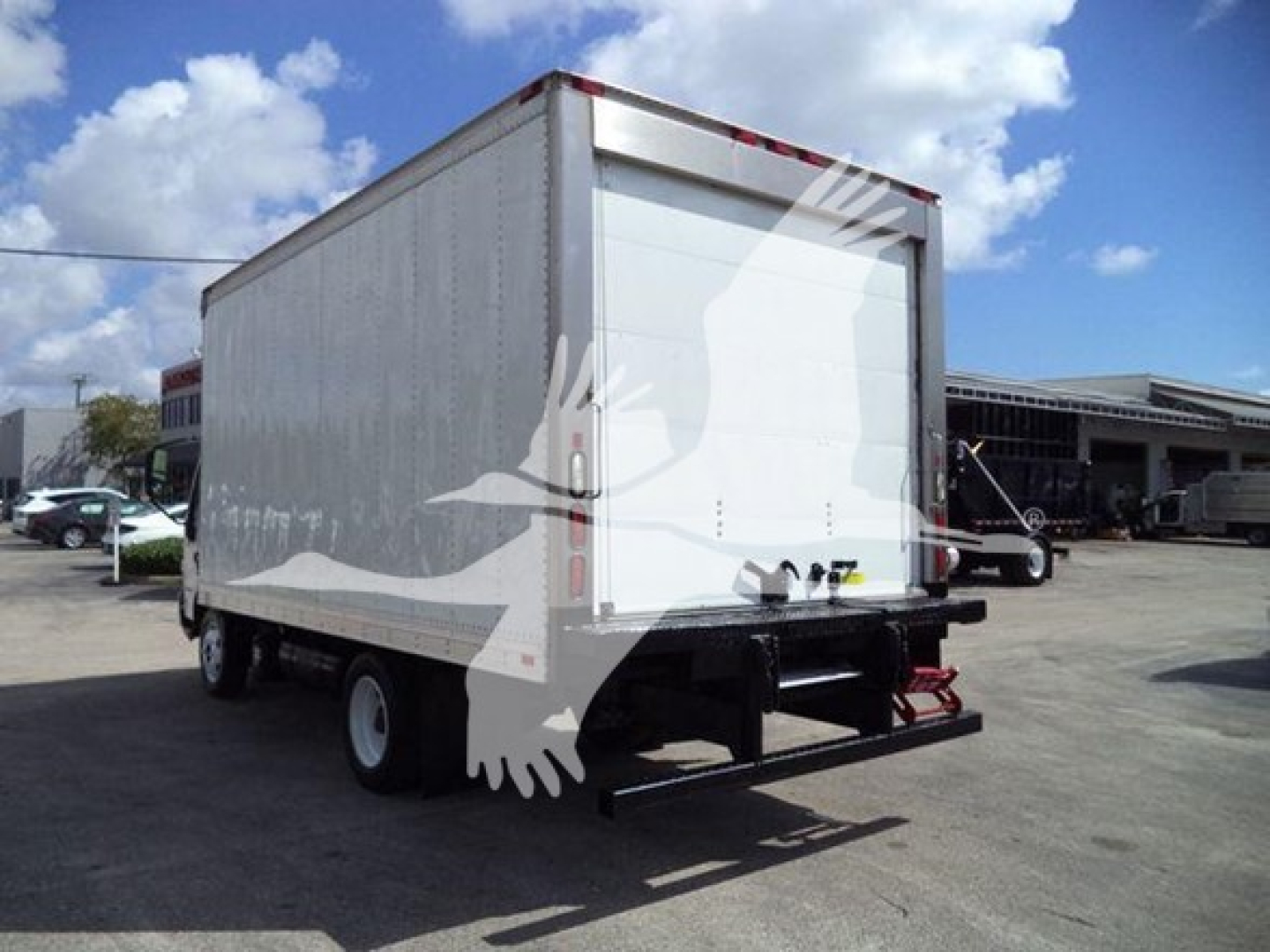 Rear and side view of a 2019 Hino 195 refrigerated box truck showing rear doors and roll-up gate.