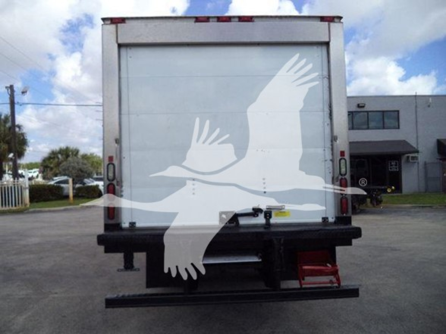 Rear view of a 2019 Hino 195 refrigerated truck showing closed cargo area and rear bumper with small red step.