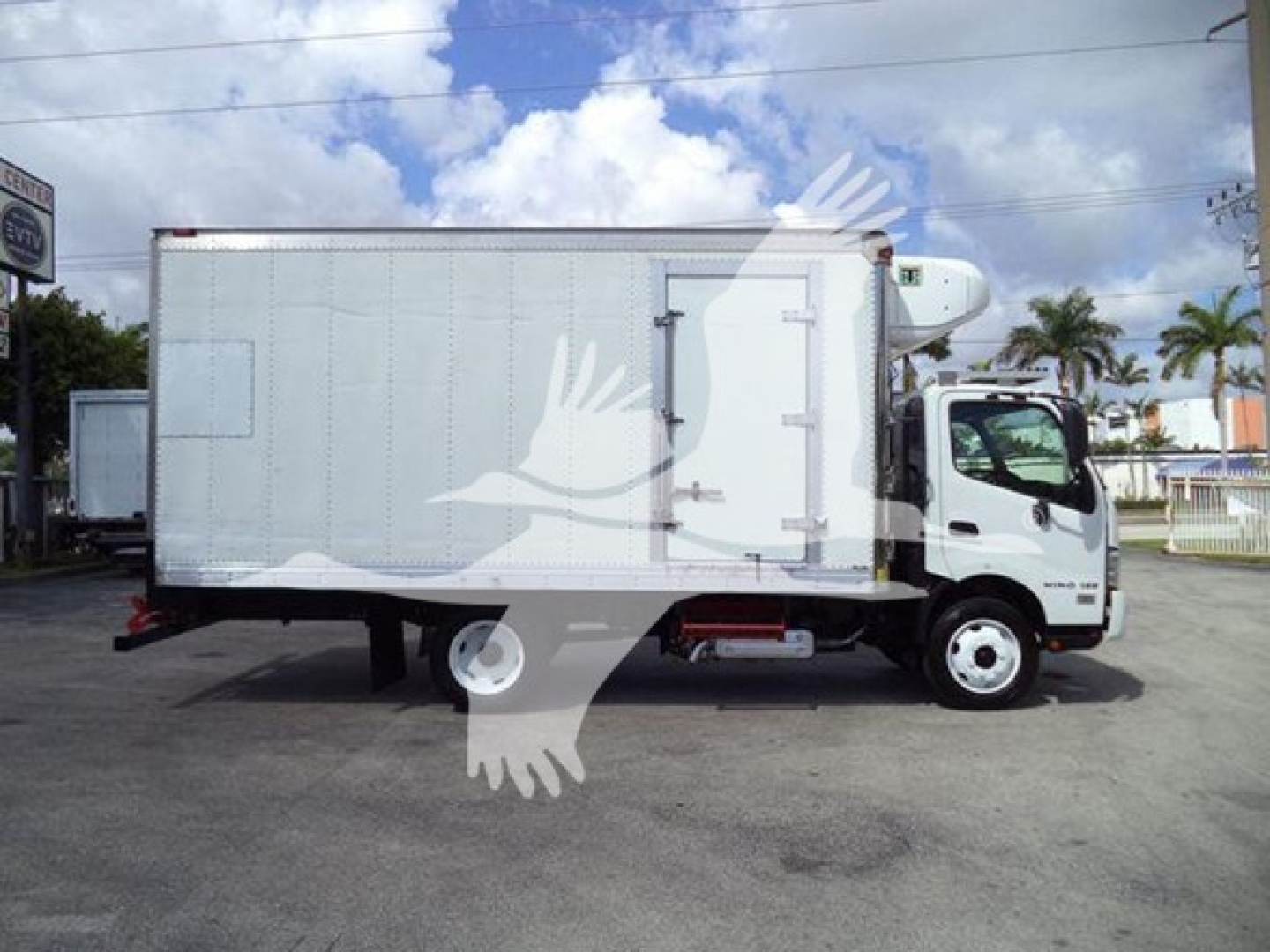 Hino 195 refrigerated truck side view showing cargo box and cab with white exterior.