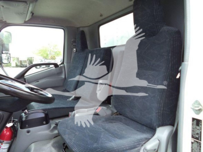 Truck cab interior showing driver and passenger seats in a refrigerated 2019 Hino 195.