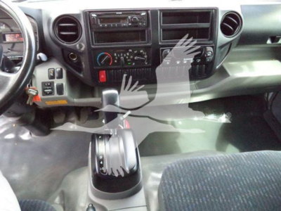 Cab interior of a 2019 Hino 195 refrigerated truck showing dashboard, controls, and gear shift