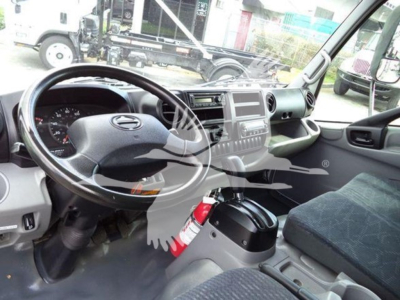 2019 Hino 195 interior showing steering wheel, dashboard, and front passenger area with fire extinguisher mounted near console.