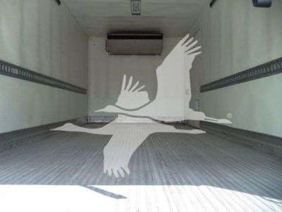 Truck cargo area showing empty refrigerated box with ribbed floor and ceiling mount, inner walls, and a hanging unit at the front.