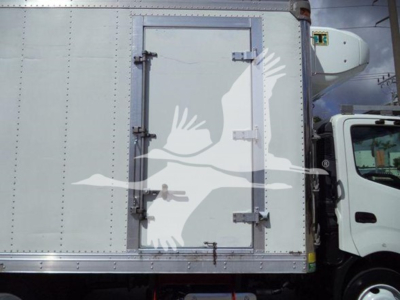 Truck refrigerated body side showing rear access door with latches and hinges