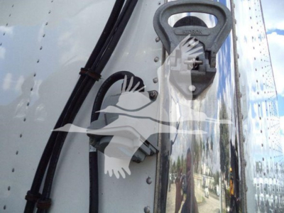 Rearview showing a metal refrigerated truck with an integrated lift ring and wiring harness on the side panel.