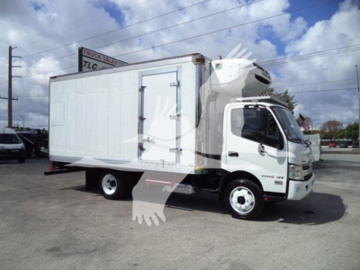 2019 Hino 195 refrigerated truck side view showing cab and box with white exterior and side door.