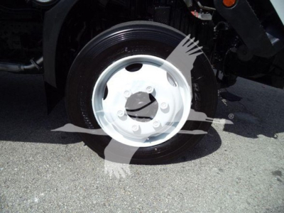 Wheel and rim close-up on a refrigerated 2019 Hino truck showing steel wheel and tire in a bay view.