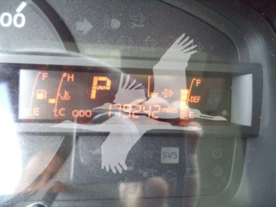 Dashboard cluster showing digital odometer reading 179,242 miles and various indicators; P gear displayed; fuel gauge and temperature icons visible.