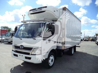 Hino 195 refrigerated truck in view showing Thermo King refrigeration unit on cab roof and white cargo box.