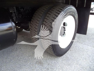 Hino 195 wheel well and tire side showing white steel wheel and tire on a refrigerated truck chassis.