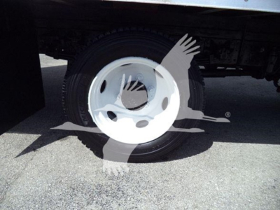 Wheel and tire on a refrigerated truck with wheel hub visible.