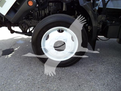 Flat side view of a Hino 195 front wheel well with white wheel and tire showing; no visible text on tire, vehicle side panels, or labels.