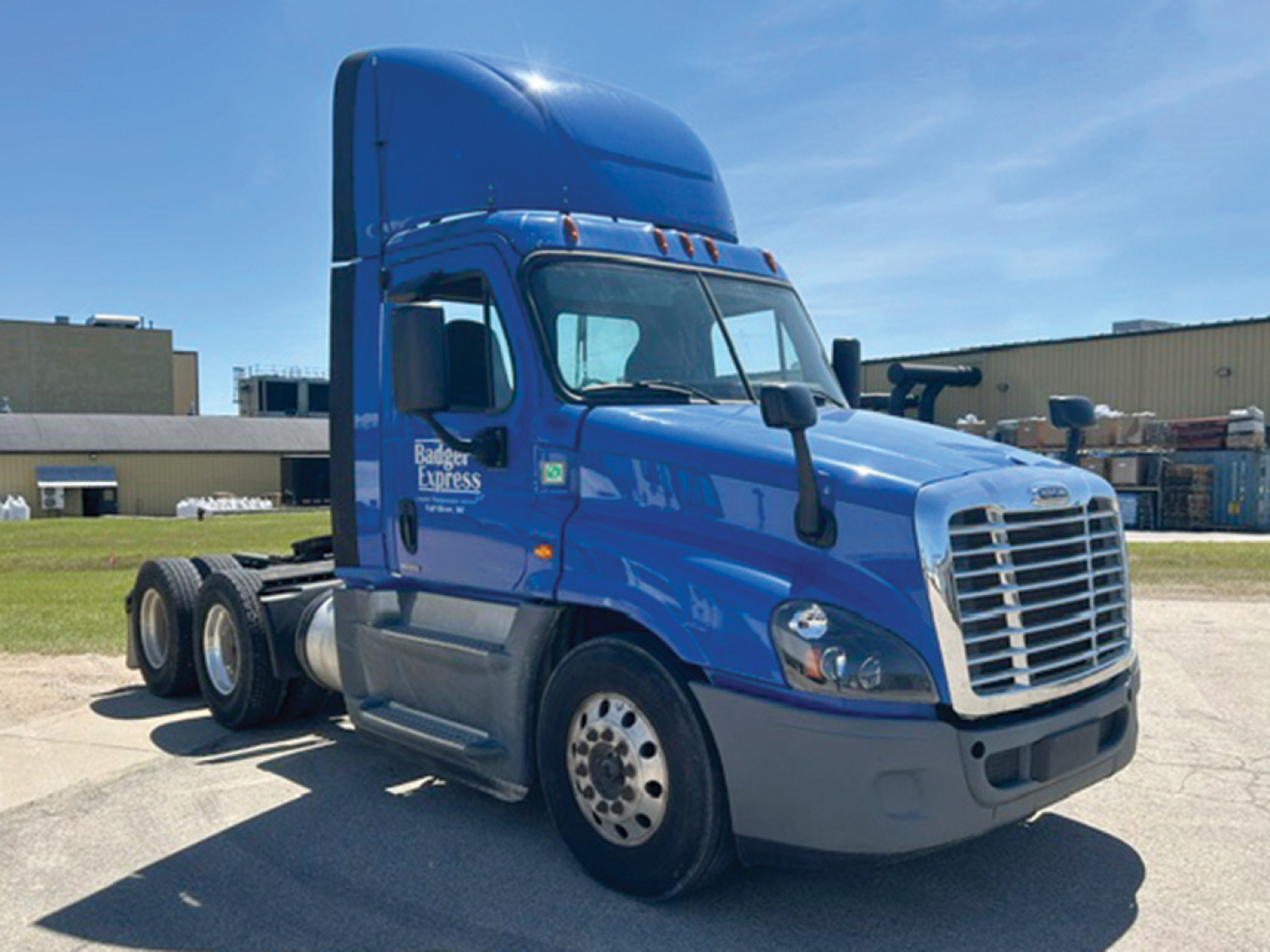 Blue Freightliner Cascadia Evolution 125 tractor cab, side view, with raised sleeper, front grille, and dual rear axles. Visible text on door includes Freightliner/Banner Express branding.