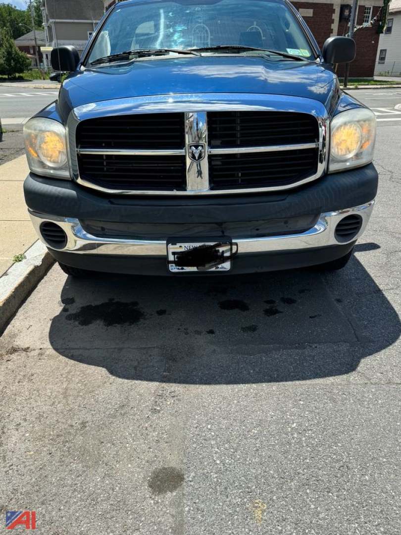Front view of a blue 2007 Dodge Ram 1500 pickup showing grille with crosshair design, chrome bumper, and headlights.