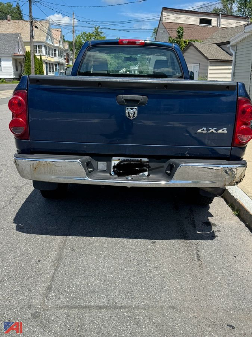 Rear view of a dark blue 2007 Dodge Ram 1500 pickup truck with 4x4 badge, chrome bumper, tailgate, and red taillights.