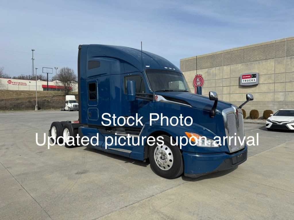 Kenworth T680 conventional sleeper truck in blue, side view showing cab and front, with stock photo watermark text.