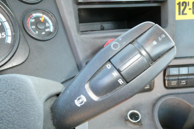 Cab view of a Freightliner Cascadia 125 showing the gear selector (PRND) lever and dashboard instruments.