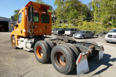Freightliner Cascadia 125 truck tractor rear view showing chassis and dual rear axles.