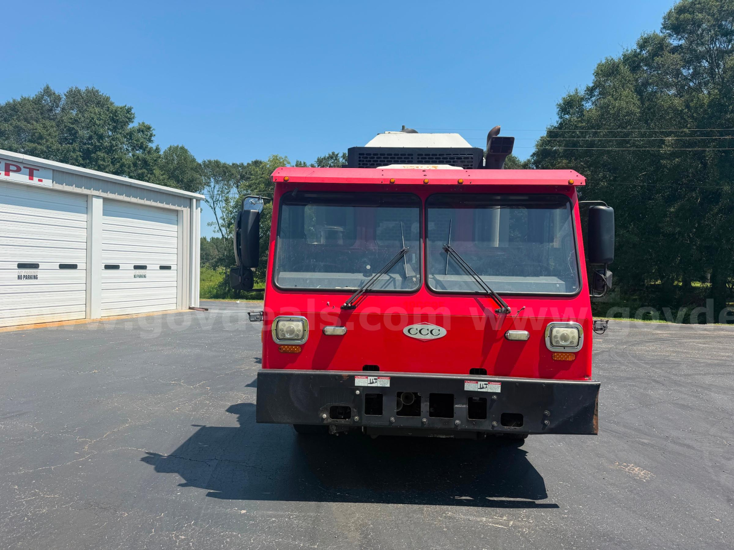Front view of a red 2019 Crane Carrier ASL truck with a large black bumper and split windshield, daytime outdoor lot, stock number 2799-868.
