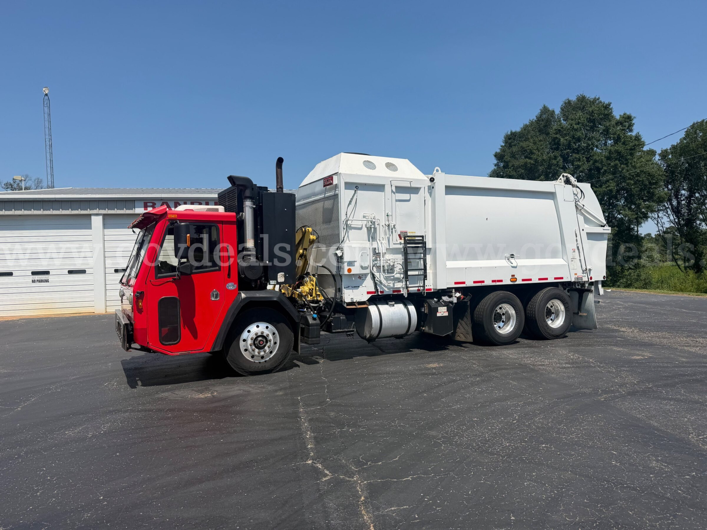2019 Crane Carrier ASL dump truck with red cab and silver dump body, side view showing crane equipment and hydraulic components.