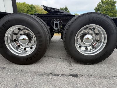 Kenworth T680 dual rear wheels showing chrome wheels and drive axle. No visible text on image.