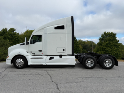Kenworth T680 tractor-trailer side view showing sleeper cab and rear wheels; no visible text on the tractor.