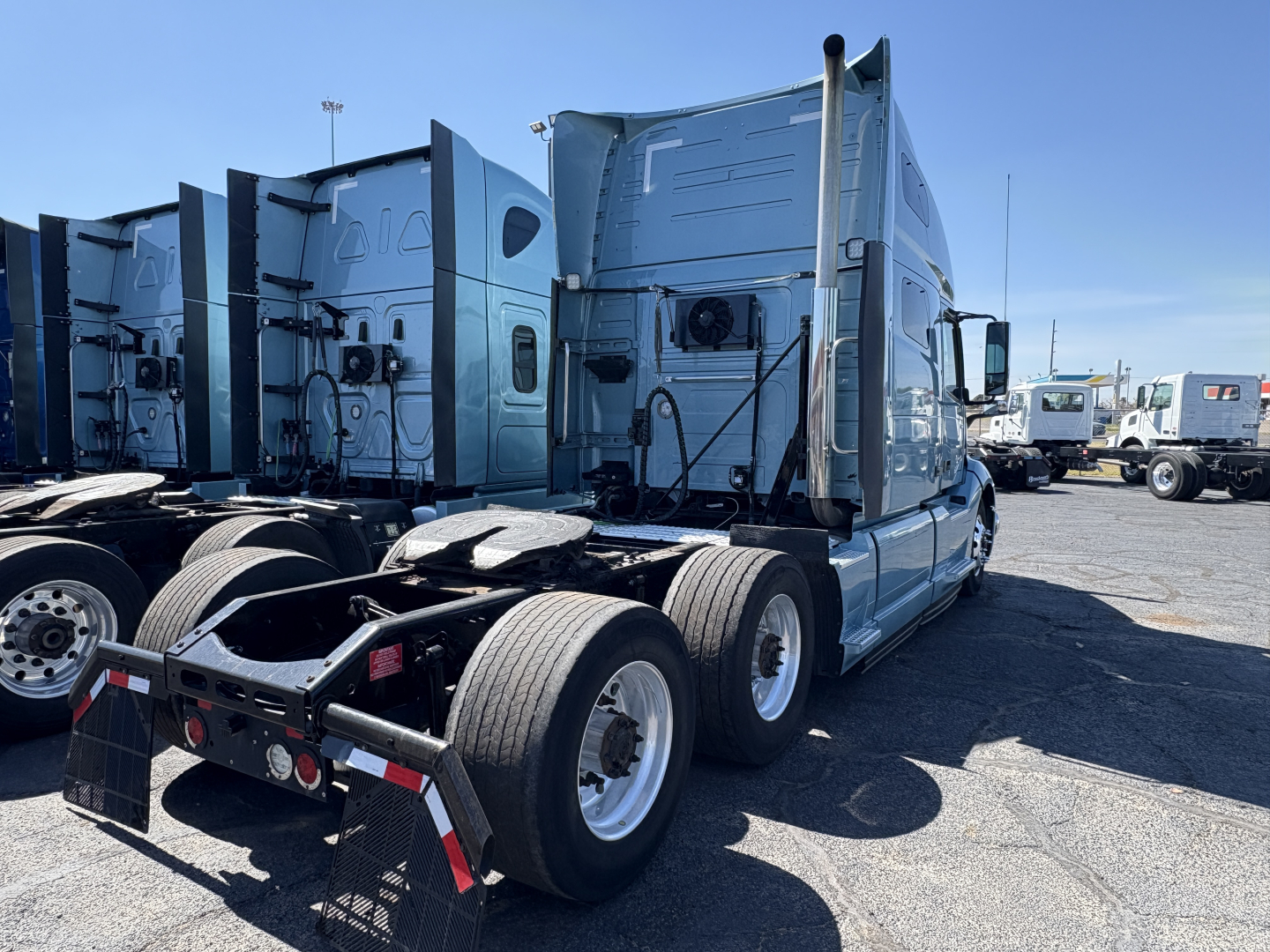 Truck chassis and sleeper cab showing rear and side of a Volvo VNL64T760 tractor with dual rear axles and blue paint; no legible labels visible