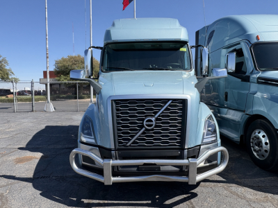 Front view of a blue 2022 Volvo VNL64T760 truck showing grille, bumper guard, and chrome mirrors.
