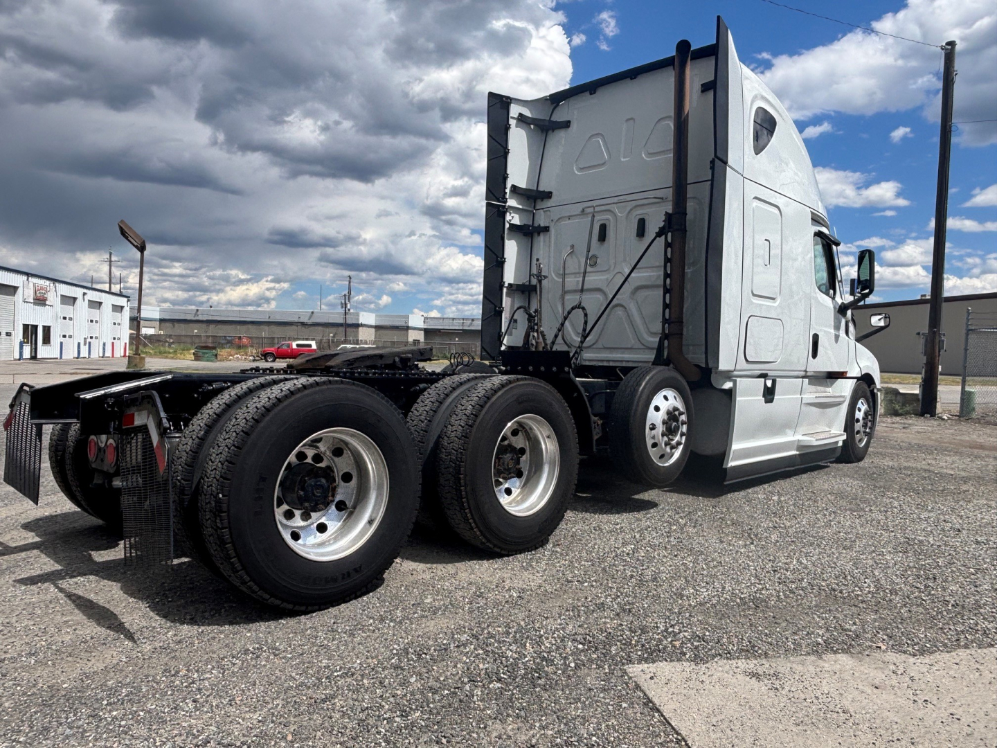 Truck: 2021 Freightliner CA-126 conventional sleeper tractor, rear three-quarter view showing dual rear axles and sleeper cab, VIN 3AKNHHDR5MSMJ7721 visible on listing