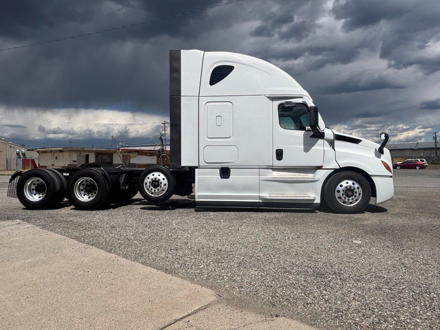 Freightliner conventional sleeper tractor side view showing CA-126 model, white cab, 3 axles, chrome fuel tanks, and sticker area.
