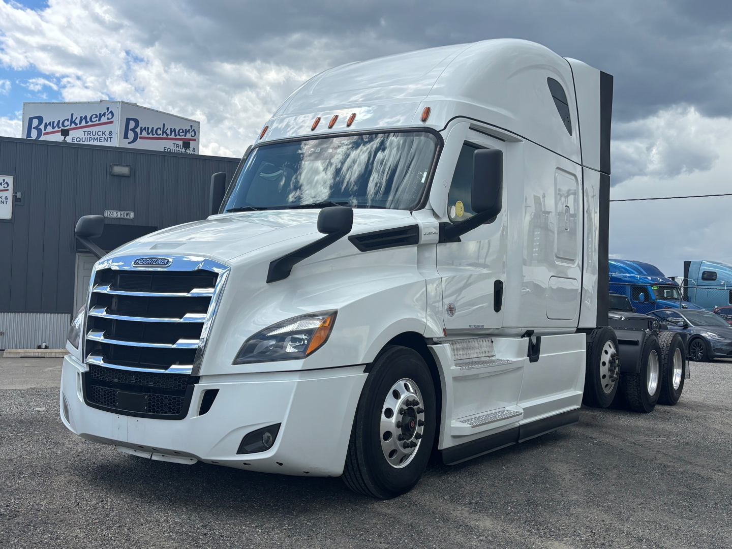 Freightliner CA-126 sleeper tractor unit, front three-quarter view, white exterior, chrome grille, dual rear axles, visible cab features.