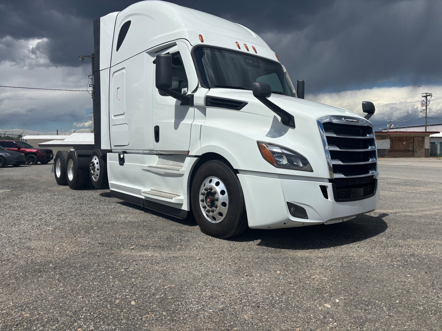 Freightliner CA-126 tractor-trailer cab in white, front three-quarter view, with sleeper design and dual rear axles.