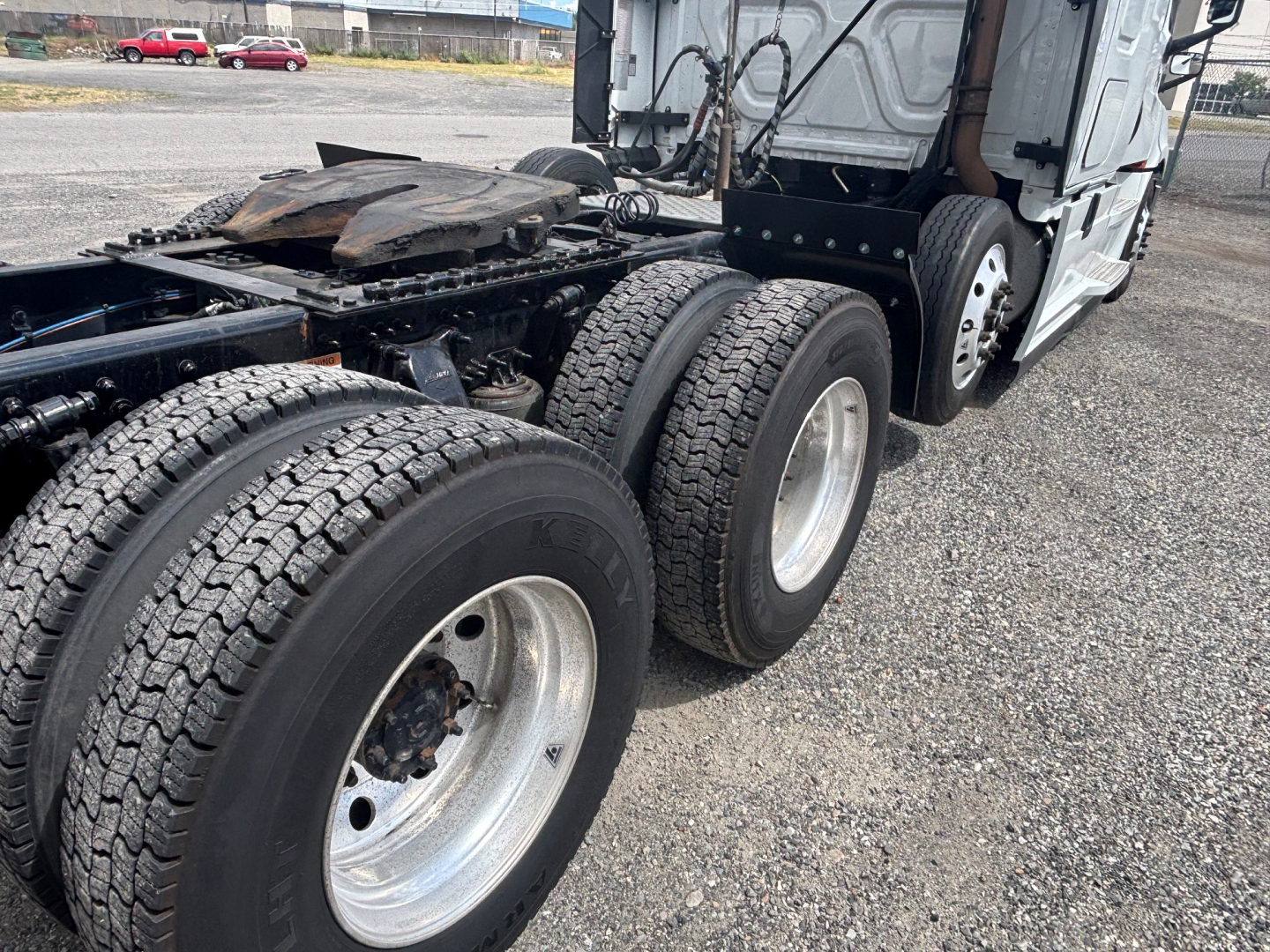 Freightliner CA-126 truck chassis showing dual rear axles and tires with metal rims, cab at rear, undercarriage and fifth wheel area visible.