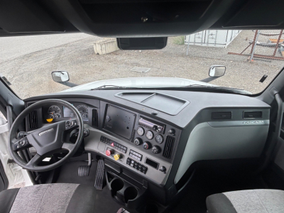 Freightliner CA-126 truck dashboard and steering wheel view with gauges and controls in the cab.