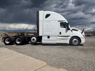 Freightliner conventional sleeper tractor side view showing CA-126 model, white cab, 3 axles, chrome fuel tanks, and sticker area.