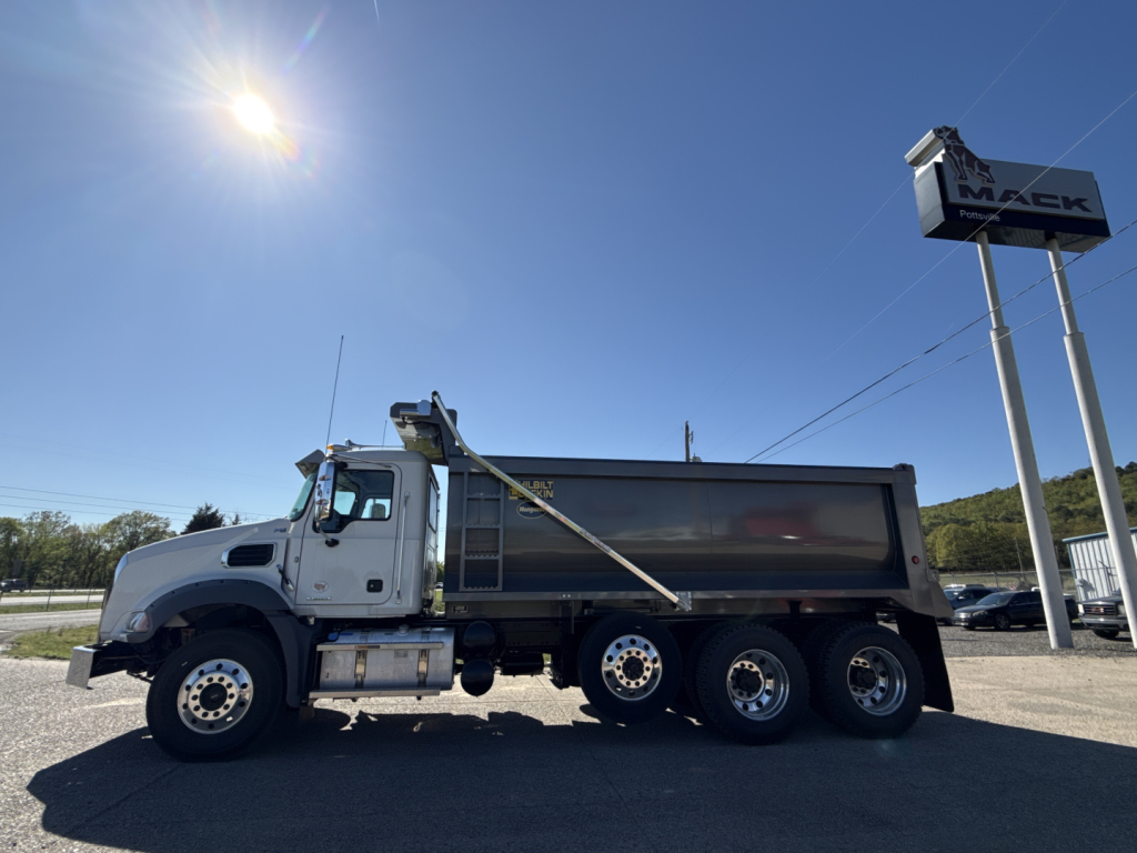 Mack GR84B dump truck side view showing driver cab, long dump body, and rear wheel tandems.