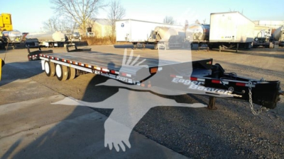 Flatbed trailer showing Eager Beaver 20Xpt branding with dual tandem axles and a black frame.