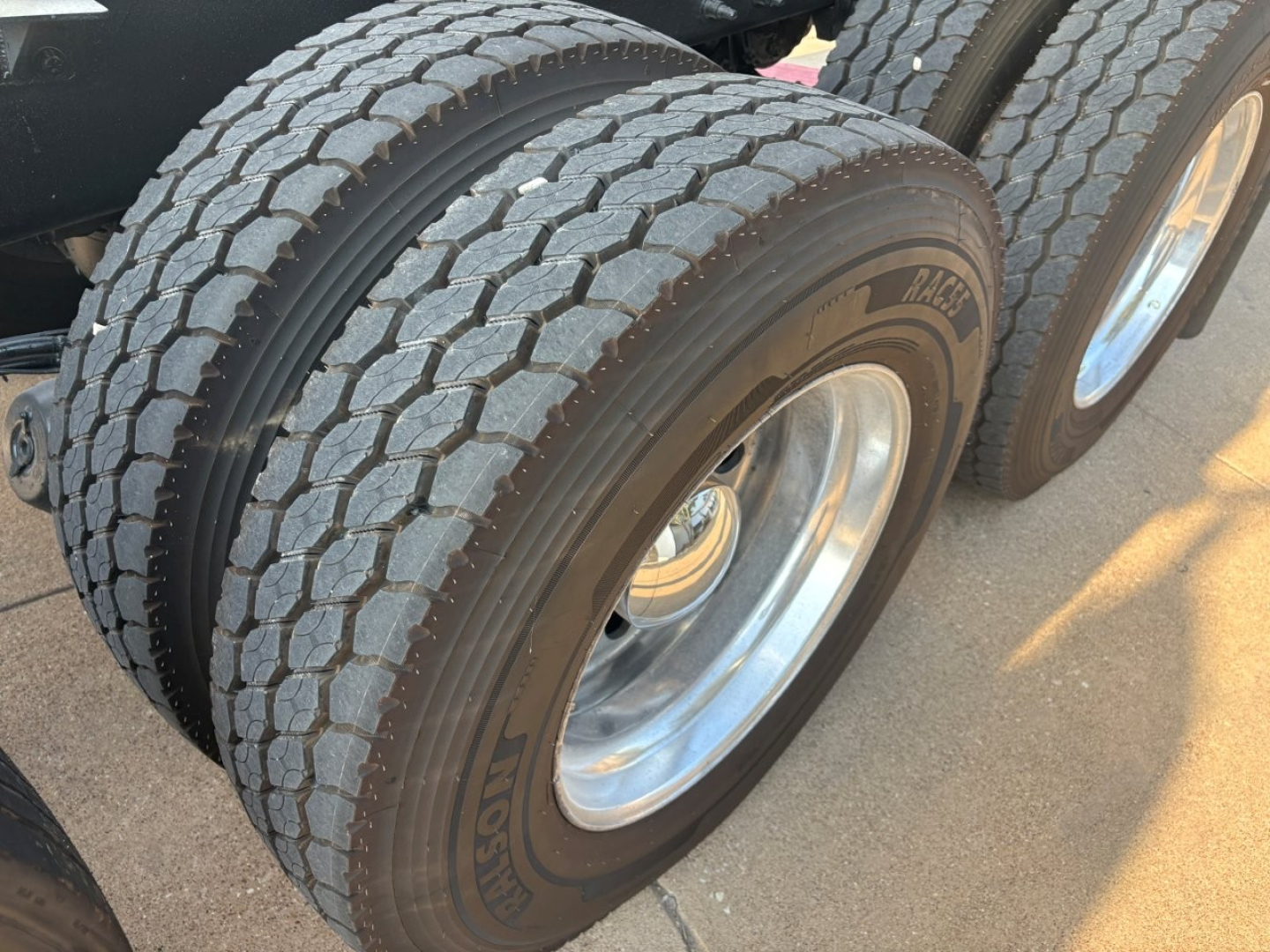 Mack GR64F truck dual rear wheel showing tires with tread pattern and rims.
