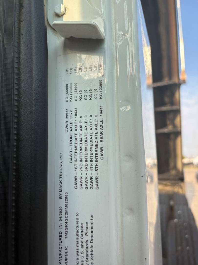 Mack GR64F truck label on door frame with VIN and axle/gross weight specifications visible; text includes GAWR, GAWR, and various weight ratings.