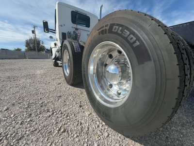Kenworth T880 front wheel and side cab showing Goodyear Dura-? tire with chrome wheel and white cab.