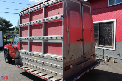 2003 GMC Sierra 2500HD cab chassis rear view showing tall cargo box with vertical side rails and aluminum framing.