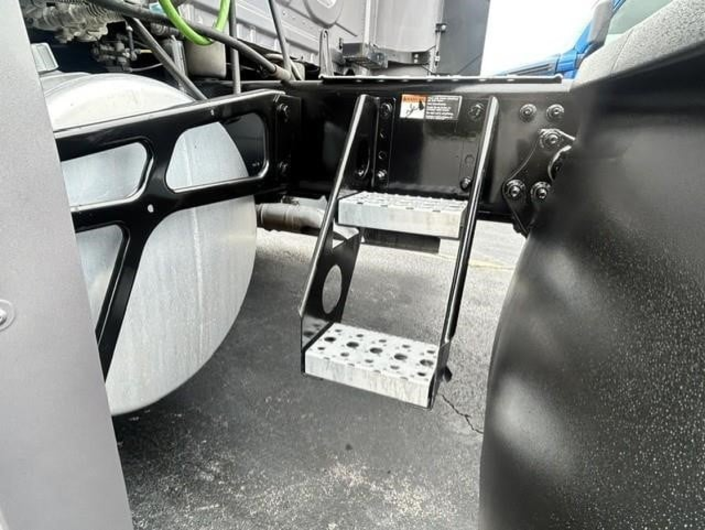 Freightliner Cascadia 126 chassis area showing metal step and mounting brackets under cab.