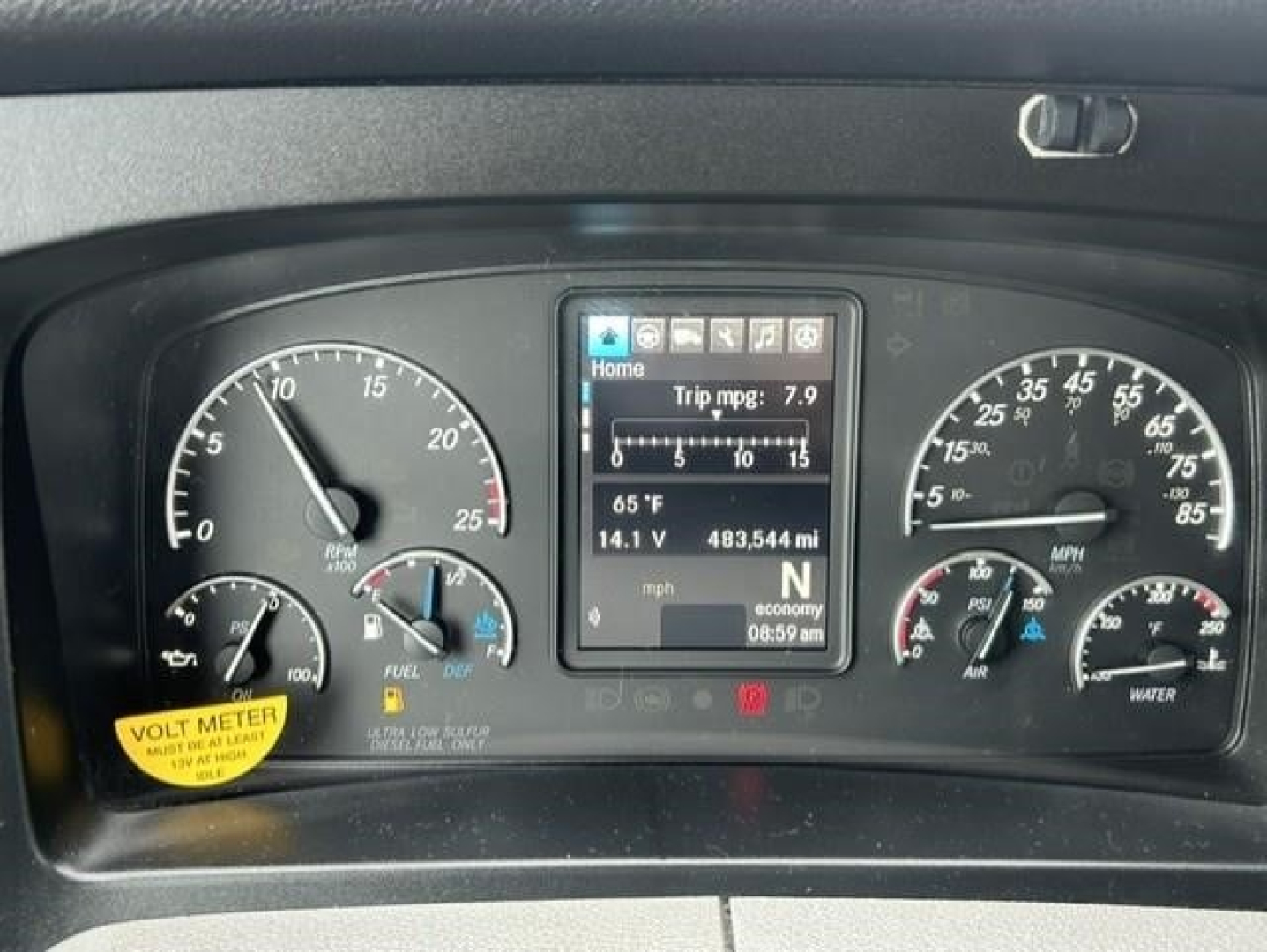 Dashboard of a 2022 Freightliner Cascadia 126 showing instrument cluster and center touchscreen with trip data, gauges for speed, RPM, fuel, DEF, and coolant; small yellow Volt Meter sticker visible.